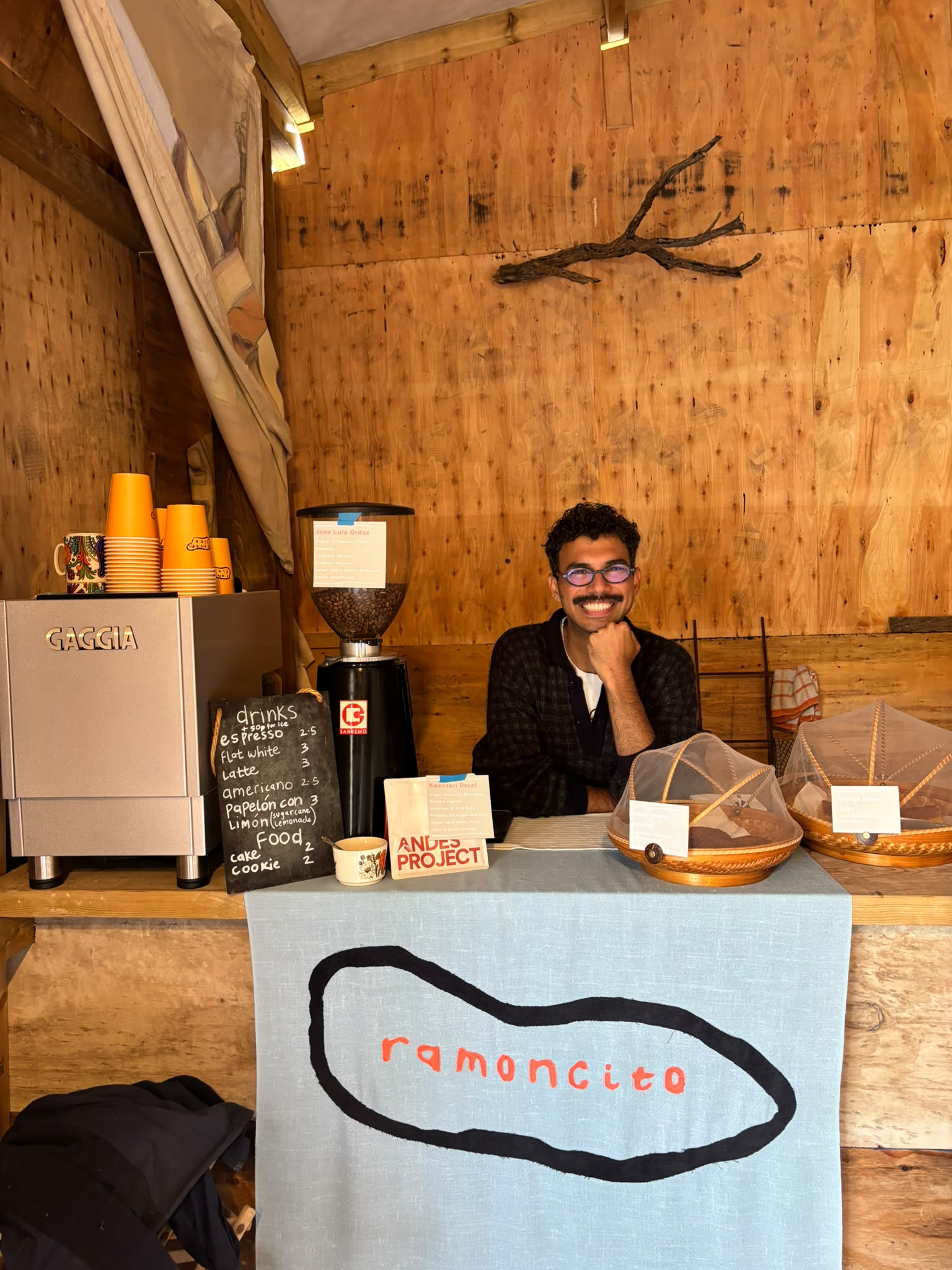 Ramoncito coffee stand with the espresso machine, bakes and hand-painted banner